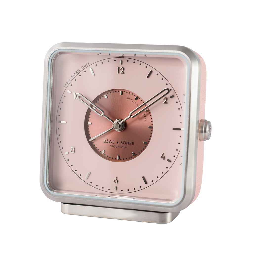 Magnolia-colored dial and silver numbers of 'Magnolia Memories' alarm clock, set within a matte-polished frame