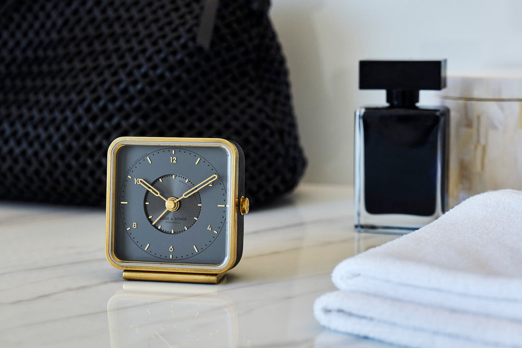 Sleepy Rock' alarm clock resting on a minimalist stand, embodying luxurious precision
