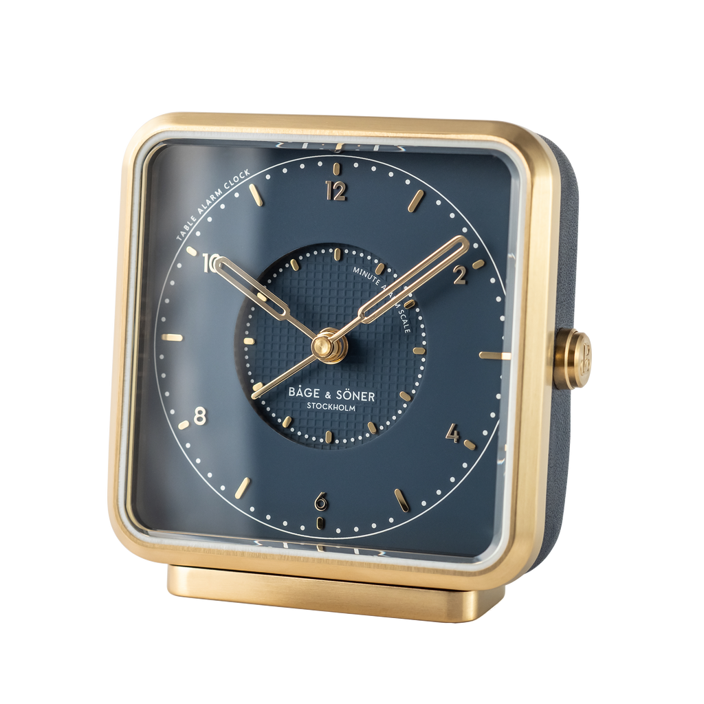 Chic 'Starry Sky' alarm clock displaying a blue dial with gold numbers and a brushed gold-plated frame