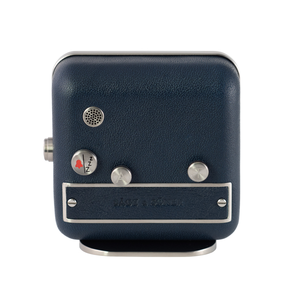Rear view of 'Afternoon Delight' alarm clock featuring a matte-polished stainless steel casing and blue leather