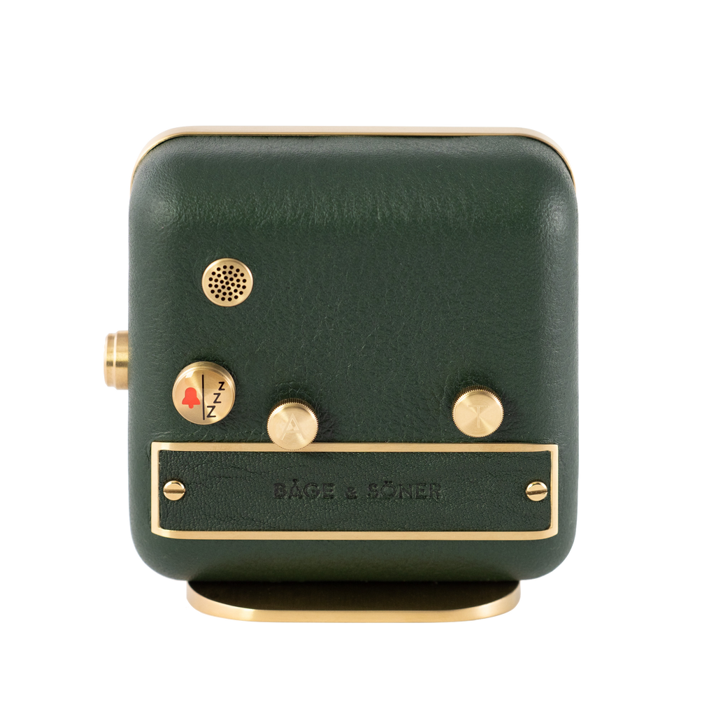 Green leather and brushed gold-plated steel frame the back of 'Forest Dream' alarm clock.