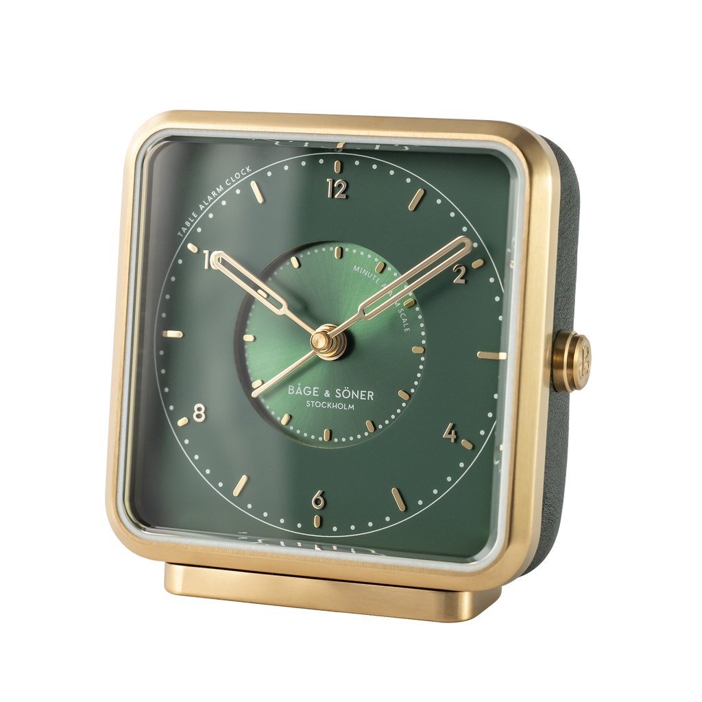 Sophisticated 'Forest Dream' alarm clock featuring a green dial with gold numbers and sunray motif.