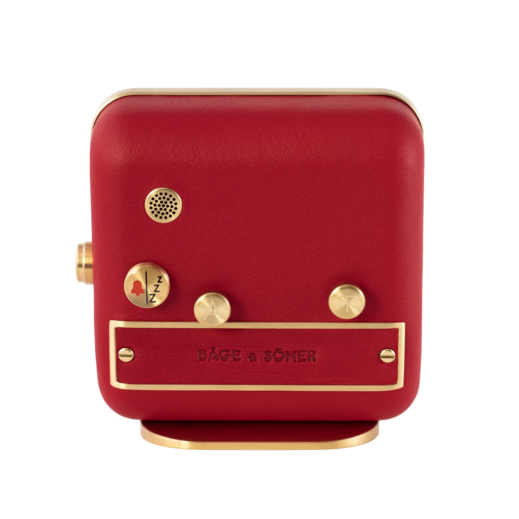 The back view of 'French Kiss' alarm clock, with brushed gold-plated steel and vivid red leather