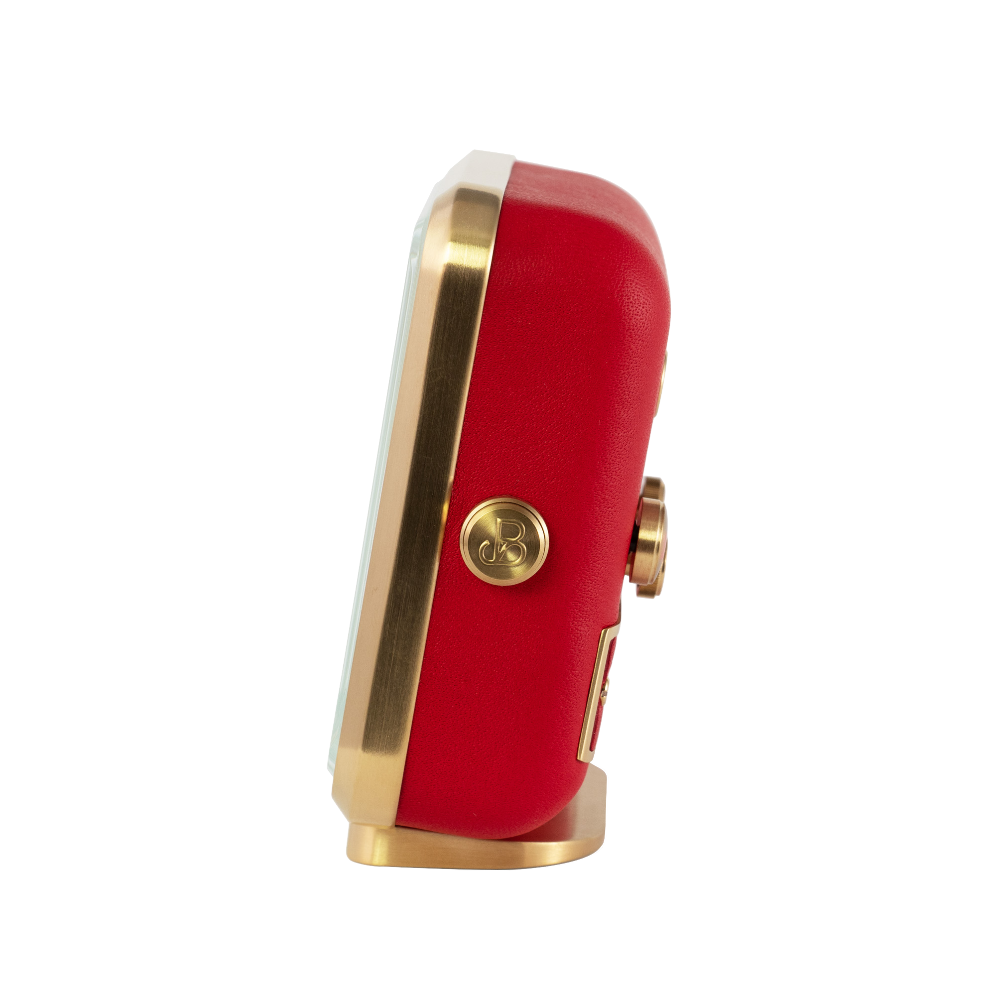 Gold-plated frame and rich red leather captured from the side of 'French Kiss' alarm clock