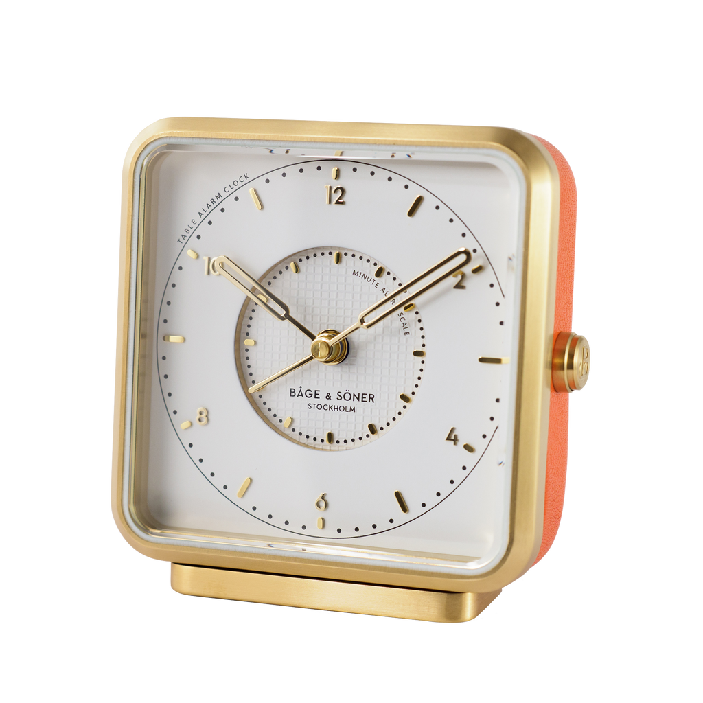 Exquisite 'Everglow' alarm clock with white dial, gold numbers, and sunray motif on the alarm zone