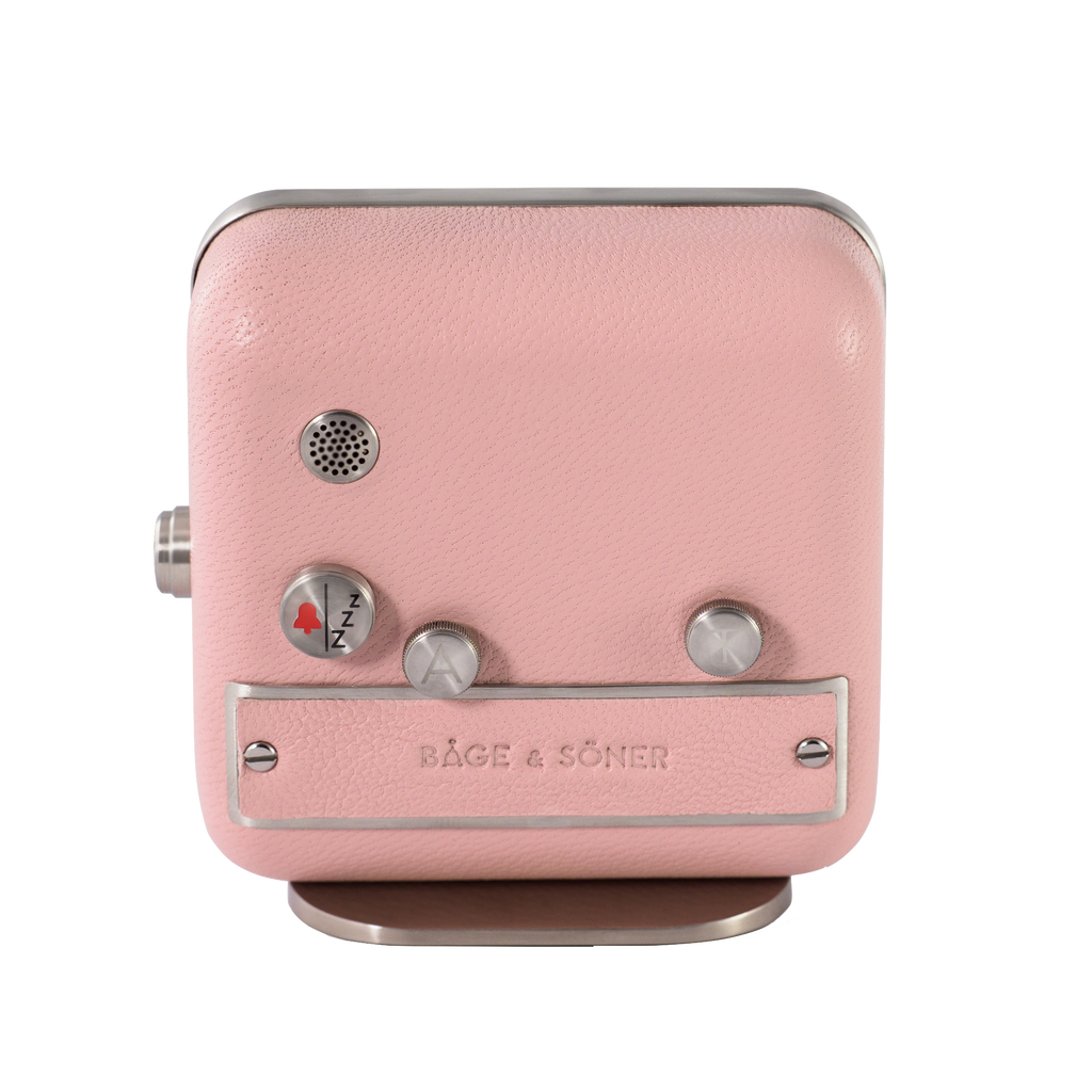 Rear angle showcasing the matte-polished stainless steel and magnolia leather of 'Magnolia Memories' alarm clock