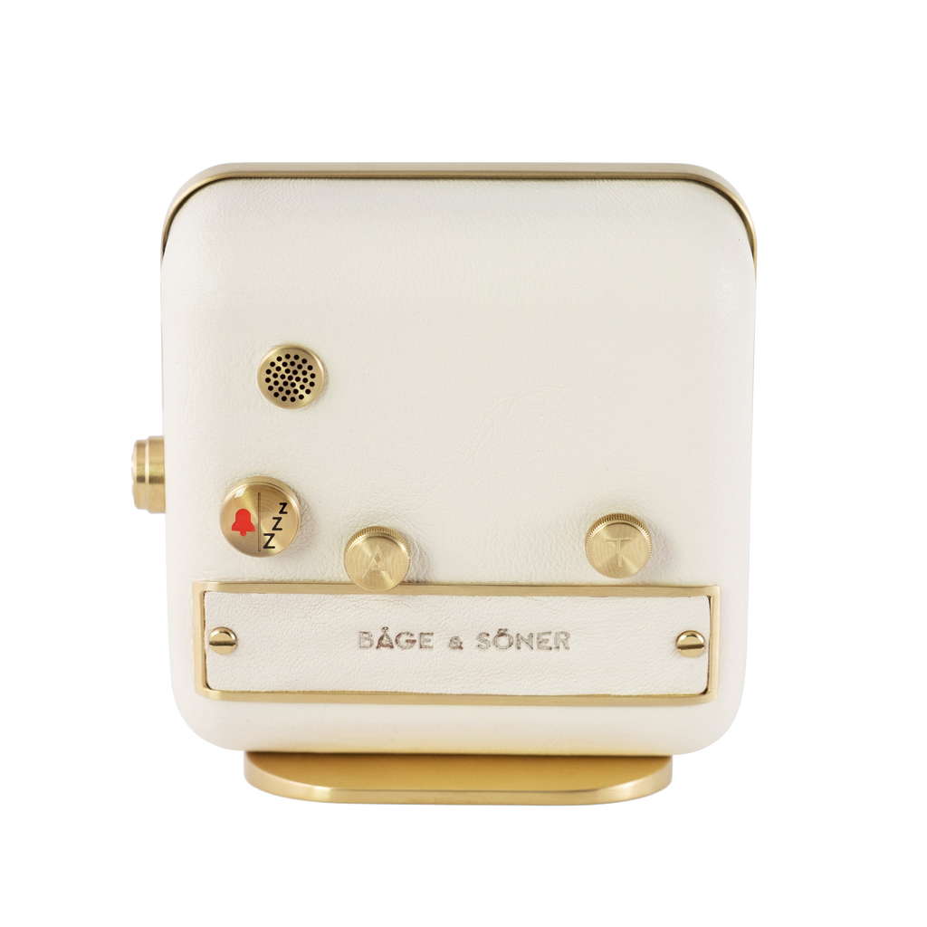 Back view of 'Morning Glory' alarm clock, highlighting the pristine white leather and gold-plated steel