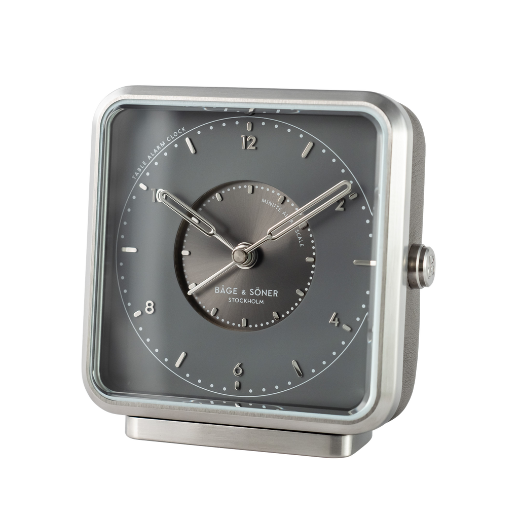 Sophisticated 'Nightfall' alarm clock with a gray dial and silver numbers within a matte-polished stainless steel frame