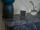 Nightfall' alarm clock in a modern decor, its gray tones reflecting modern elegance