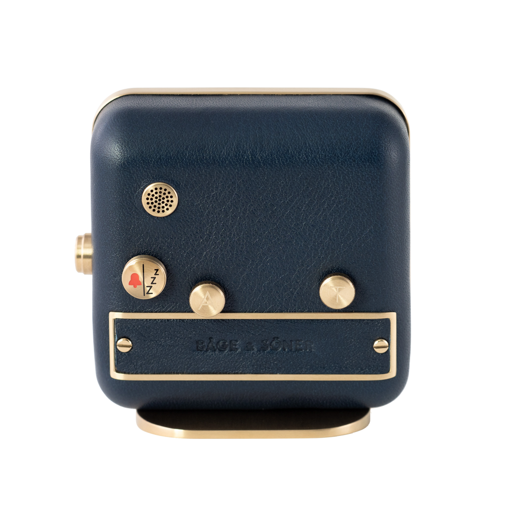 The brushed gold-plated steel and blue leather back of the 'Sea Breeze' alarm clock