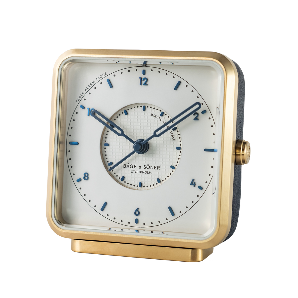 Refined 'Sea Breeze' alarm clock with a white dial and blued numbers, set in a brushed gold-plated frame
