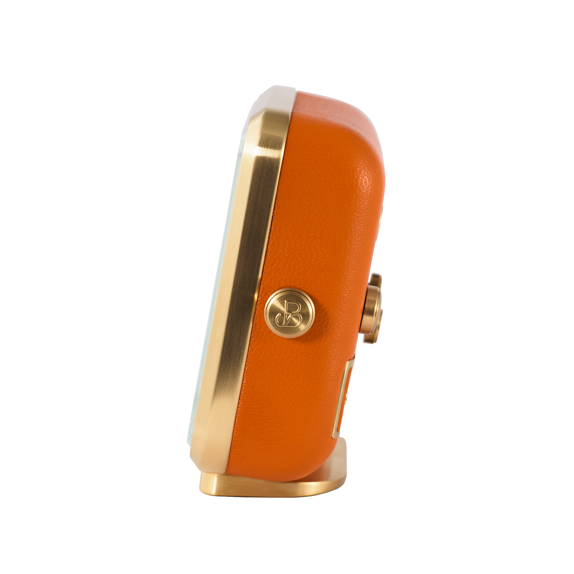 Gold-plated edge and vibrant orange leather highlight the side view of 'Everglow' alarm clock