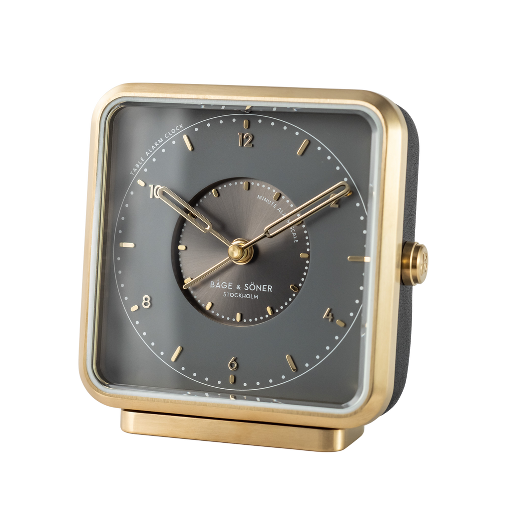 Refined 'Sleepy Rock' alarm clock with a rhodium-gray dial and gold numbers, brushed gold-plated steel frame