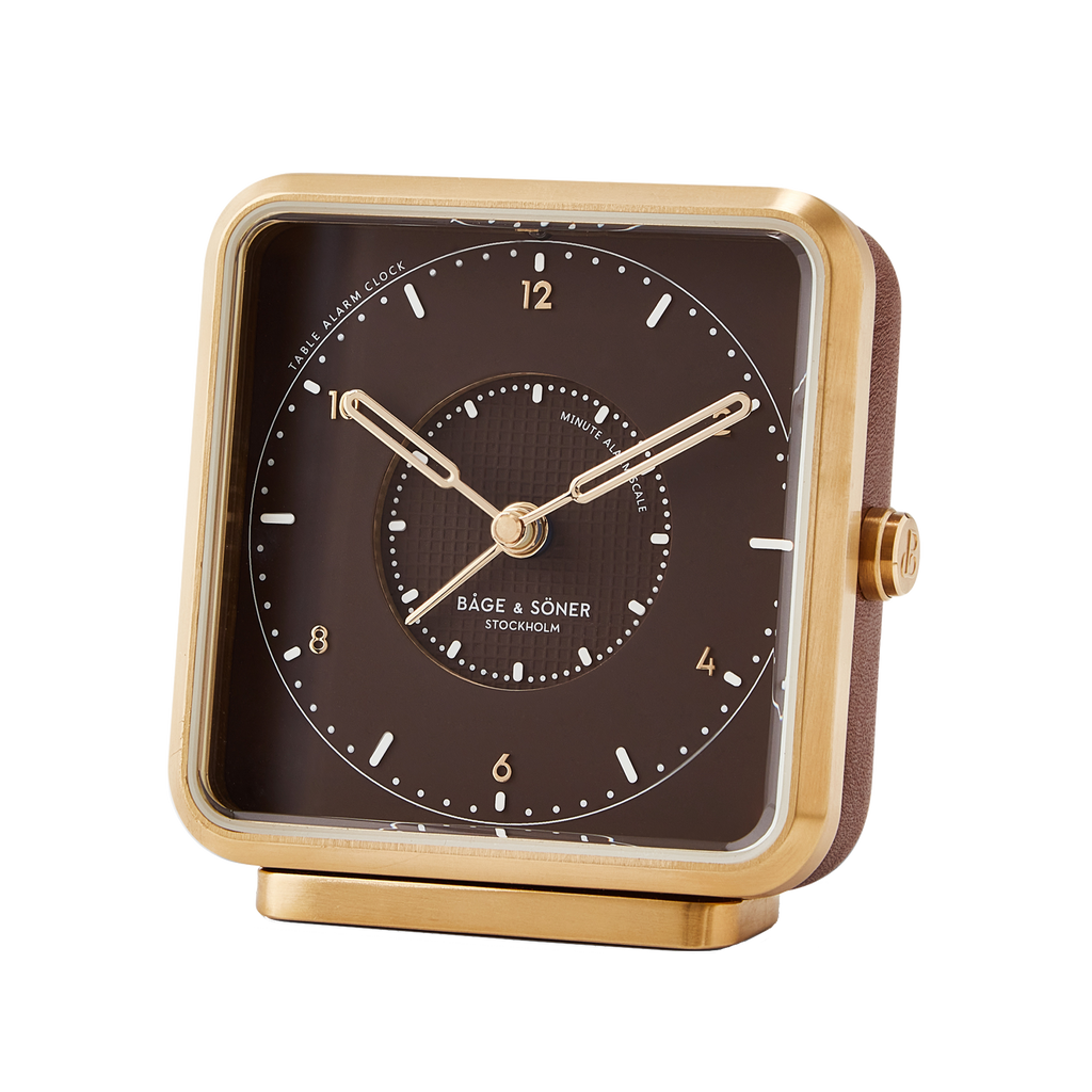 Sophisticated 'Dreamland Gold' alarm clock with a brown dial and brushed PVD gold-plated frame